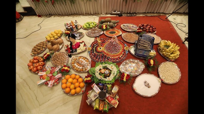 Bride seated beside grand plated fruit and sweet display