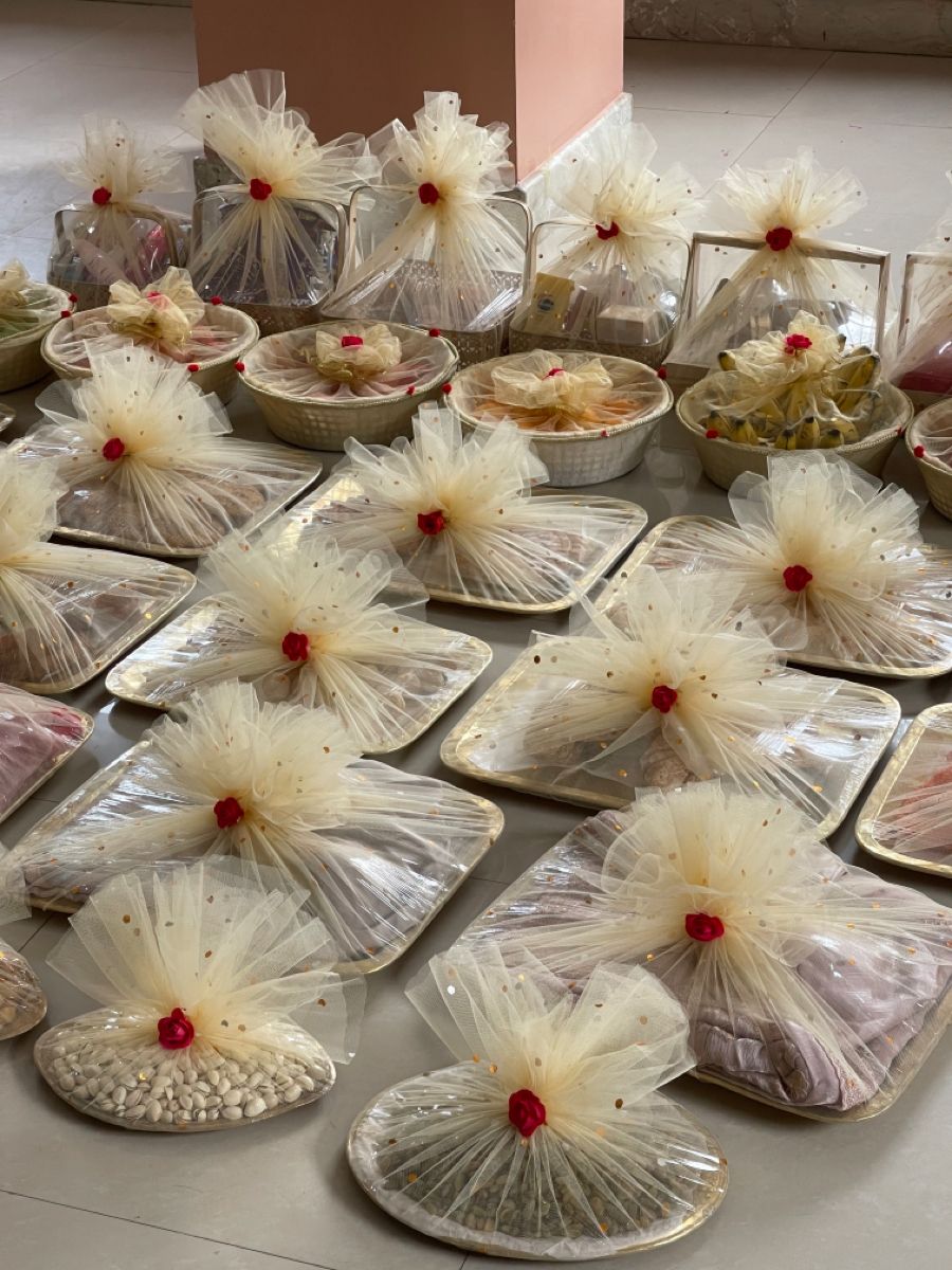 Wedding tambulam trays wrapped in cream net with red roses