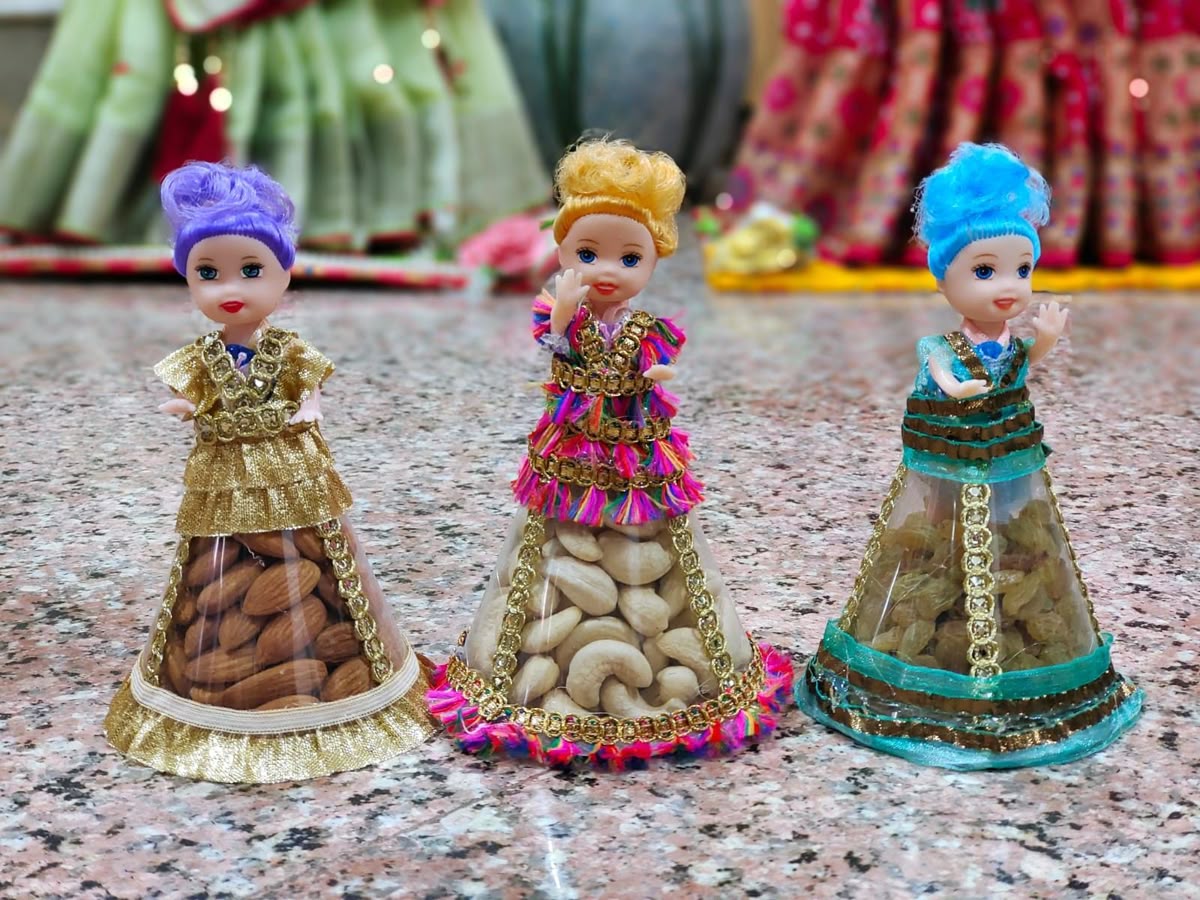 Doll-dress dry fruit favours with almonds, cashews and raisins