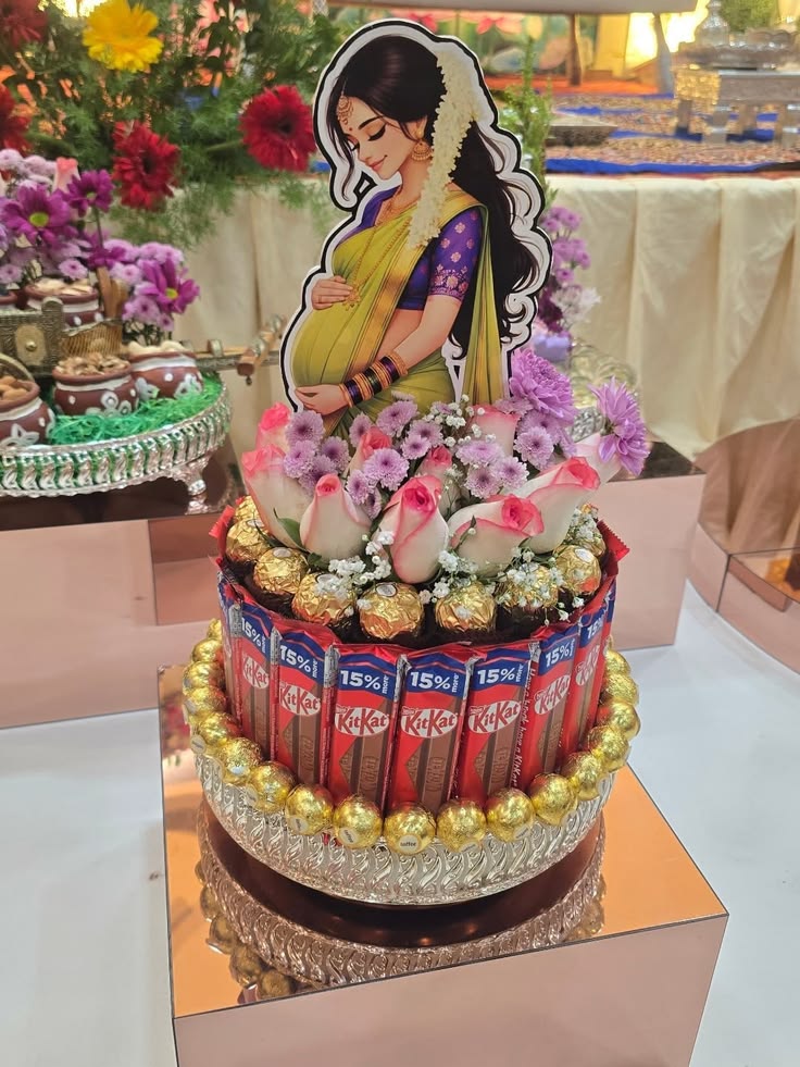Baby shower cake with KitKat, Ferrero Rocher and floral topper