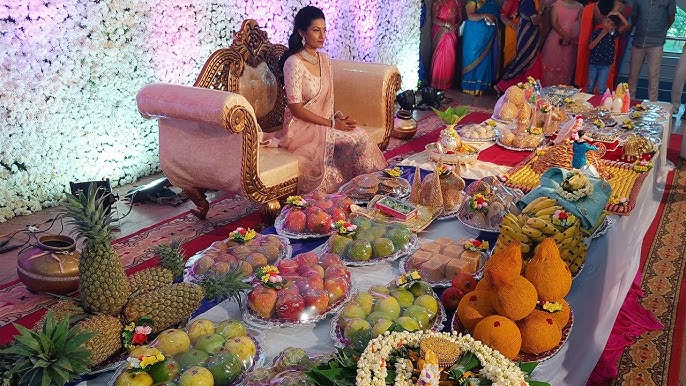 Circular plated arrangement of fruits, sweets and dry fruits