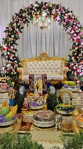 Floral arch with plated ceremonial trays